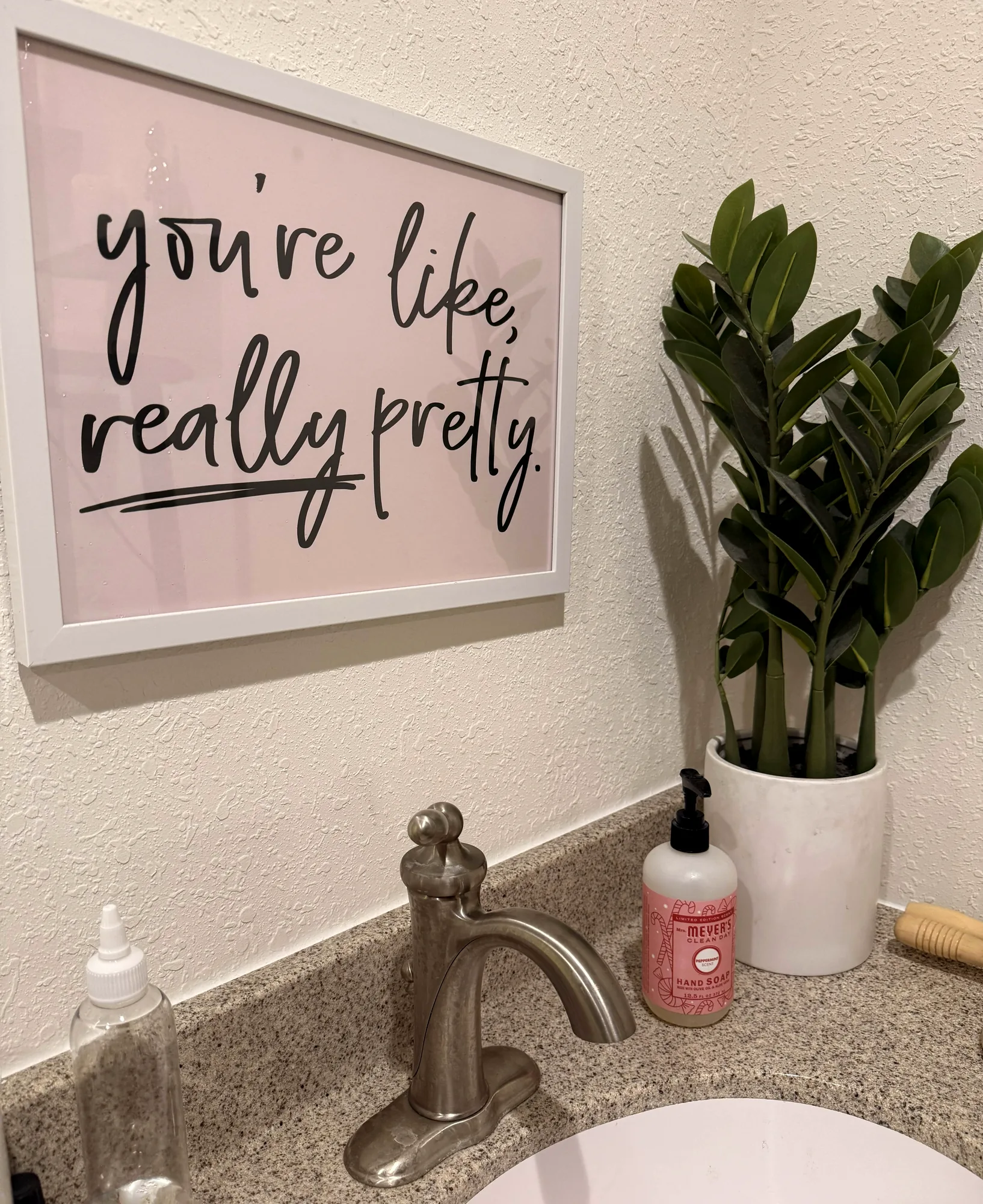 A framed sign reading "you're like, really pretty"